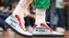 FILE - Enes Kanter Freedom wore these shoes urging that China not host the 2022 Winter Olympic Games when the Boston Celtics hosted the Chicago Bulls in Boston, Nov 1, 2021.