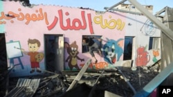 A Palestinian gets out of a building destroyed in an overnight Israeli bombardment in Rafah, Gaza Strip, Nov. 24, 2023.