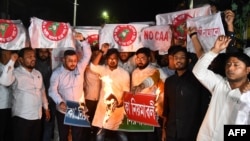 Opponents of the Indian government's Citizenship Amendment Act (CAA) rally against its implementation, with some setting mock copies of the CAA on fire, during a protest in Guwahati, India, March 11, 2024.