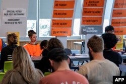 Voters wait to get their ballot papers to cast votes in the 2023 New Zealand general election at a voting center in Wellington on Oct. 14, 2023.