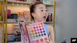 In this photo released by Yan Guanghua Yan Guanghua, one of TikTok earliest livestreamers in China, conducts a livestream from her studio in Shenzhen in southern China's Guangdong province in July 2023.