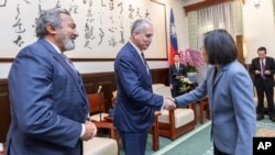 In this photo released by the Taiwan Presidential Office, Taiwan's President Tsai Ing-wen shakes hands with U.S. Rep. Mario Diaz-Balart of Florida and Rep. Ami Bera of California, left, in Taipei, Taiwan, on Jan. 25, 2024. 