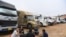 FILE - Truck drivers gather at a makeshift parking lot where Vietnamese container trucks are waiting to cross the Vietnam-China border in Lang Son province on Jan. 7, 2022.