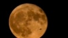 FILE - An airliner flies in front of a supermoon, the first of four this year, on July 3, 2023, in Chicago. August will feature two supermoons.