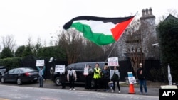 Protesters call for a cease-fire in the Israel-Hamas war as they demonstrate outside the home of US Secretary of State Antony Blinken in Arlington, Virginia, on Jan. 27, 2024.