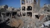 Palestinians look at buildings destroyed in the Israeli bombardment in Deir al Balah, Gaza Strip, Nov. 7, 2023.