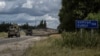 Ukrainian soldiers ride military vehicles from a crossing point at the border with Russia in the Sumy region of Ukraine on Aug. 13, 2024.