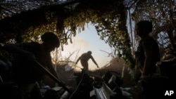 Ukrainian servicemen of the 148th separate artillery brigade of the Air Assault Forces prepare a M777 howitzer to fire toward Russian positions at the front line in the Donetsk region, Ukraine, Aug. 21, 2024.