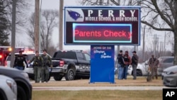 Police respond to a shooting at Perry High School in Perry, Iowa, Jan. 4, 2024. Police said a 17-year-old student killed one child and wounded five other people.