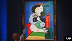 Sotheby's employees take phone bids during the 'The Emily Fisher Landau Collection: An Era Defined' auction for Pablo Picasso's 'Femme a la Montre' at Sotheby's in New York City on Nov. 8, 2023. 