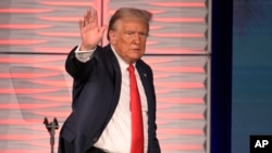 FILE - Former US President Donald Trump acknowledges attendees after speaking at the Republican Party of Florida Freedom Summit, Nov. 4, 2023, in Kissimmee, Fla.