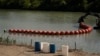 Biden Administration Sues Texas Over Floating Barrier Meant to Stop Migrants
