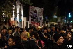 Protesters hold up portraits of hostages during a rally near the residence of the Israeli prime minister in Jerusalem on Jan. 22, 2024, The demonstration was organized by family and supporters of Israeli hostages held in Gaza since the Oct. 7 attacks by Hamas in southern Israel.