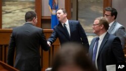 Ronald Fein, attorney for the petitioner, Free Speech for People, left, shakes hands with Donald Trump's attorney Nicholas Nelson, center, after they argued their cases before the Minnesota Supreme Court, Nov. 2, 2023 St. Paul, Minn.