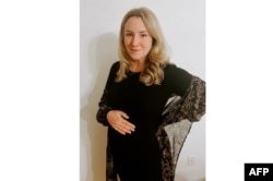 This undated handout photo provided by Kate Cox shows her standing in Dallas-Fort Worth, Texas. The Texas mother of two unsuccessfully sued her state to get an abortion because her fetus had a rare genetic disorder.