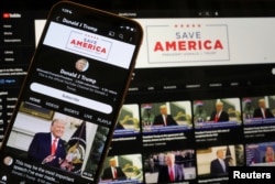 FILE - Former U.S. President Donald Trump's YouTube account is seen on a mobile phone and laptop computer after being restored by Google and its parent company Alphabet Inc, March 17, 2023.