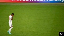 England's Marcus Rashford reacts after missing a penalty in a shootout against Italy at the Euro 2020 soccer championship final at Wembley stadium in London, Sunday, July 11, 2021. (John Sibley/Pool Photo via AP, File)