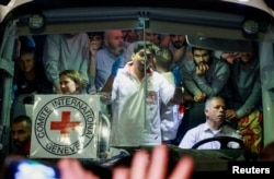 Released Palestinian prisoners react from inside a vehicle after leaving the Israeli military prison, Ofer, amid a hostages-prisoners swap deal between Hamas and Israel, near Ramallah in the Israeli-occupied West Bank, Nov. 26, 2023.