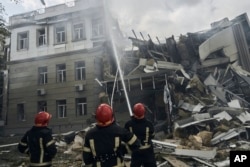 Emergency service personnel work at the site of a destroyed building after a Russian attack in Odesa, Ukraine, July 20, 2023.