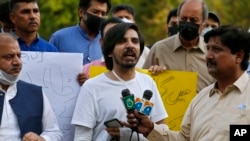 FILE - Pakistani journalist Asad Ali Toor, center, speaks during a demonstration called by a journalists union to condemn attacks on journalists, in Islamabad, May 28, 2021.