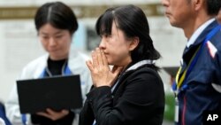 Staff of Japan Aerospace Exploration Agency watch a live streaming of the pinpoint moon landing operation by the Smart Lander for Investigating Moon (SLIM) spacecraft at JAXA's Sagamihara Campus, Jan. 20, 2024, in Sagamihara near Tokyo.