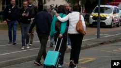 A student leaves the Gambetta high school after a man armed with a knife killed a teacher in Arras, northern France, Oct. 13, 2023.