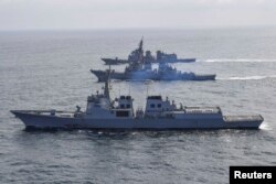 FILE - South Korean Navy destroyer Yulgok Yi I, U.S. Navy destroyer USS Benfold and Japan Self-Defense Force destroyer Atago take part in joint naval missile defense exercises in international waters between Korea and Japan, April 17, 2023.