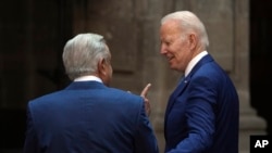 FILE - President Joe Biden and Mexican President Andres Manuel Lopez Obrador chat prior to having the official photo taken during the North America Summit, at the National Palace in Mexico City, Jan. 10, 2023