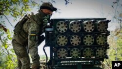 A Ukrainian soldier prepares a multiple rocket launcher to fire towards Russian positions at a front line near Bakhmut, Donetsk region, Ukraine, July 10, 2023.