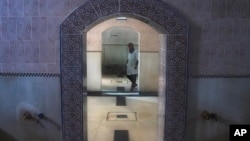 A worker walks inside an empty Moroccan traditional bath, known as hammam, in Rabat, Morocco, March 4, 2024.