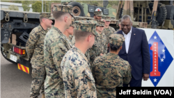 U.S. Secretary of Defense Lloyd Austin, right, visits troops taking part in Exercise Talisman Sabre in Townsville, Australia. "We are grateful for everything that you are doing," he said.
