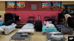 Cots for migrants are set up in the Chicago City Life Center, Nov. 29, 2023, in Chicago.