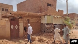 FILE - People check a damaged house in southern Khartoum on June 12, 2023 as deadly shelling and gunfire resumed after the end of a 24-hour ceasefire in Sudan.