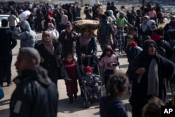 After fleeing an Israeli ground and air offensive in nearby Khan Younis, Palestinians arrive in the southern Gaza town of Rafah, Jan. 26, 2024.