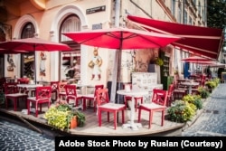FILE - Lviv outdoor cafe with red umbrellas. (Adobe Stock Photo by Ruslan)