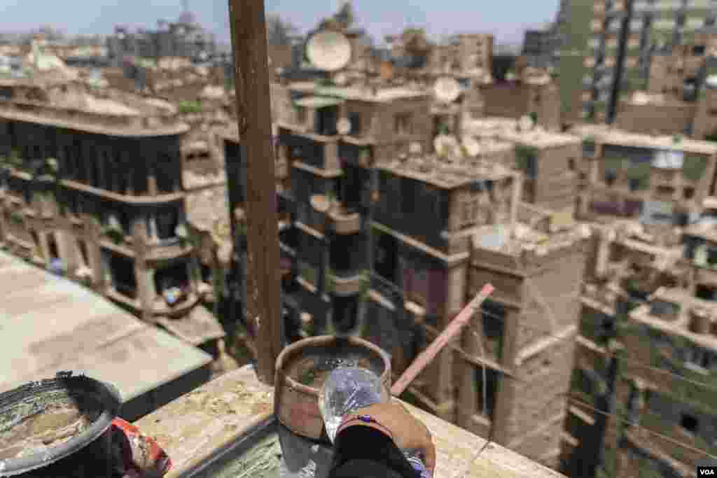 As part of an Egyptian tradition, Sharbat, 20, keeps this bowl full of water for wild birds during the peak summer months in the belief that the gesture of kindness will bring good luck to her home in Cairo. (Hamada Elrasam/VOA) 