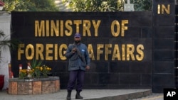 A police officer stands guard at the main entry gate of Pakistan's Ministry of Foreign Affairs, in Islamabad, Pakistan, Jan. 18, 2024.