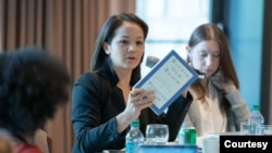 FILE - Freelance reporter Christine Herman, center, speaks at a meeting of the Rosalynn Carter Fellowships for Mental Health Journalism at the Carter Center in Atlanta, Georgia, on Sept. 18, 2019. (The Carter Center/Michael Schwarz)