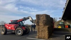 Farmers block a highway leading to Paris with hay bales, Jan. 29, 2024 near Jossigny, east of Paris.