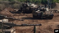 Israeli tanks are stationed near the Israeli border with Lebanon, Oct. 13, 2023.