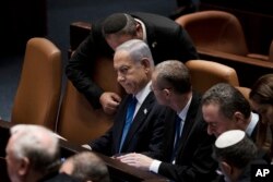 Israel's Prime Minister Benjamin Netanyahu, center, is surrounded by lawmakers at a session of the Knesset, Israel's parliament, in Jerusalem, Israel, on July 24, 2023.