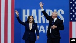 FILE - Democratic presidential nominee Vice President Kamala Harris and her running mate Minnesota Governor Tim Walz arrive at a campaign rally in Philadelphia, Aug. 6, 2024.