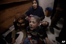 Palestinians wounded in an Israeli strike are treated in a hospital in Kahan Younis, Gaza Strip, Jan. 12, 2024.