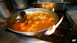 FILE - Shrimp creole is made at Antoine's Restaurant in New Orleans, Sept. 11, 2015.