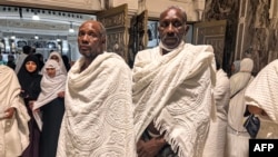 Sudanese pilgrims Kamal Kabashi (L), 52, Ahmed Jaber, 62, at Grand Mosque, as Muslims from around the world arrive for the Hajj pilgrimage in the city of Mecca, June 22, 2023.