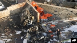 Israeli firefighters extinguish a fire after a rocket launched from the Gaza Strip hit a parking lot in Ashkelon, southern Israel, Oct. 7, 2023.