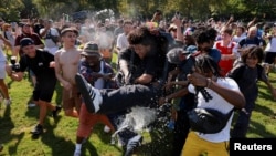 People participate in a water-balloon fight during a heat wave in Manhattan's Central Park, in New York, July 28, 2023.