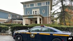 FILE - A New York State Police Department cruiser is parked in front of Cornell University's Center for Jewish Living, in Ithaca, New York, Oct. 30, 2023.