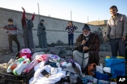 Palestinians react after their relative's home was destroyed by an Israeli airstrike in Rafah, southern Gaza Strip, Jan. 7, 2024.