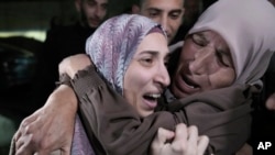 Shuruq Dwayat, left, a Palestinian prisoner released by Israel, is hugged by relatives as she arrives home in the east Jerusalem neighborhood of Sur Bahar, Nov. 26, 2023.
